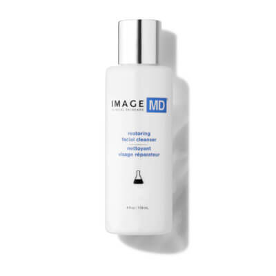 White skincare bottle with a reflective silver cap; label shows IMAGE MD and 'restoring facial cleanser' text.