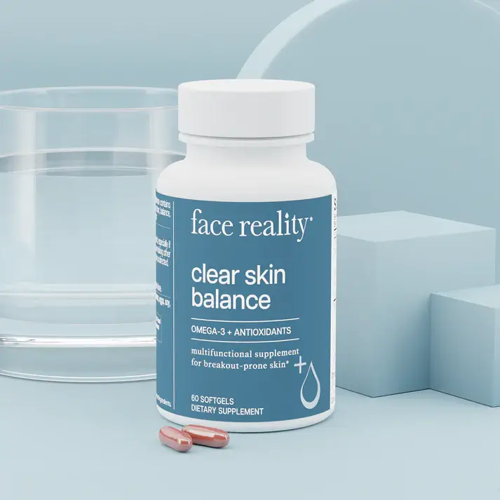 Bottle labeled face reality 'clear skin balance'Omega-3 plus antioxidants with two capsules nearby; skincare supplement scene.