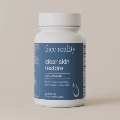 Bottle of Face Reality Clear Skin Restore dietary supplement with zinc and probiotic on a blue label.