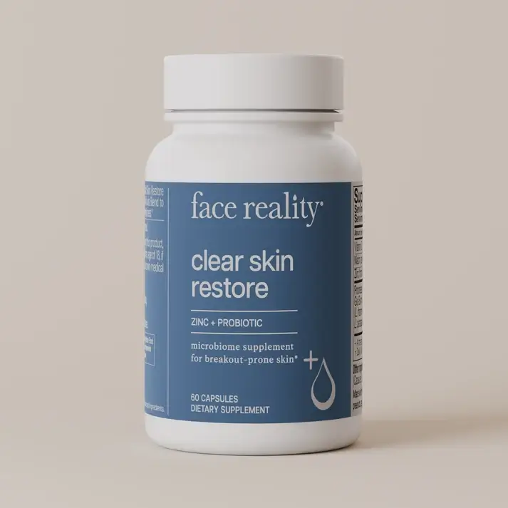 Bottle of Face Reality Clear Skin Restore dietary supplement with zinc and probiotic on a blue label.